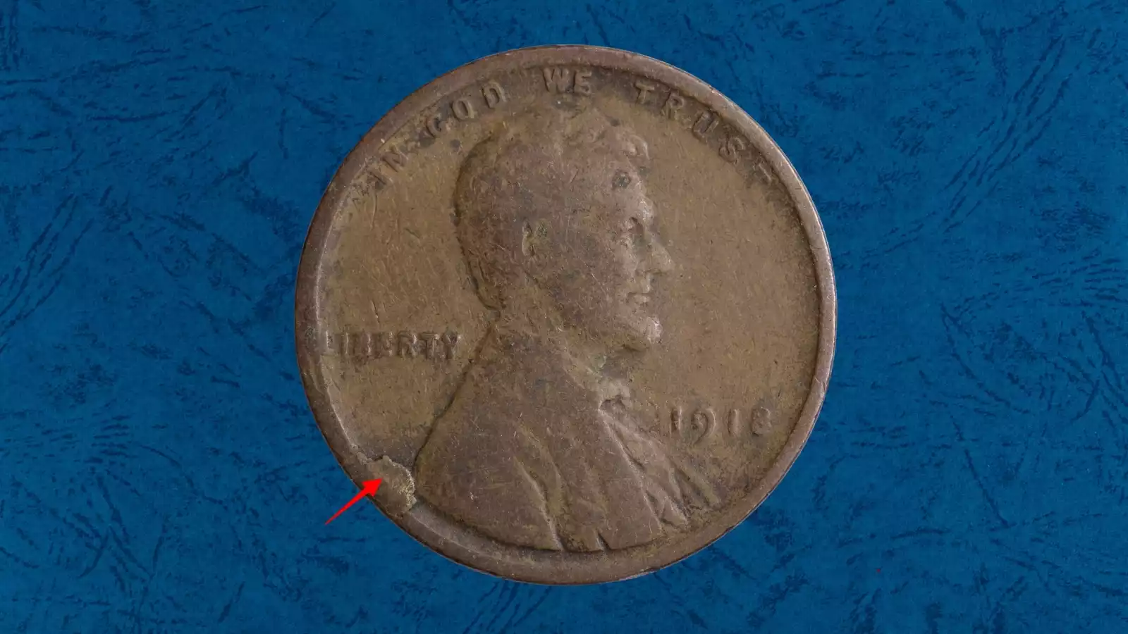 1918 wheat penny die cud error showing raised blob of metal at the rim where the die broke